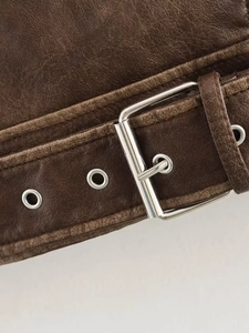 Close-up of vintage brown leather jacket belt with silver metal buckle and eyelets
