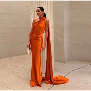 Detail of elegant orange satin halter neck dress with long ribbon and floor-length drape