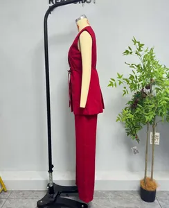 Detail view of red two-piece suit with sleeveless belted vest and straight-leg trousers