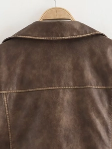 Detail view of the brown PU leather jacket collar and back stitching on a wooden hanger