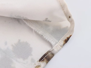 Detailed close-up of the professional stitching and dark abstract print on sleeveless dress