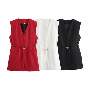 Detail of elegant sleeveless blazers in red, white and black with thin metal buckle belts
