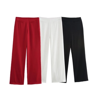 Detailed view of high-waisted wide-leg trousers in red, white and black colors