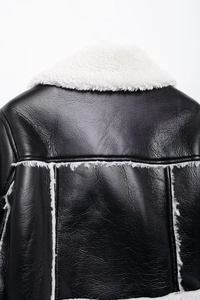 Detailed back view of a black faux leather flight jacket with white sherpa wool trim