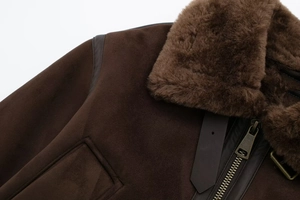 Close-up of vintage brown suede aviator jacket featuring warm plush collar and metal zipper