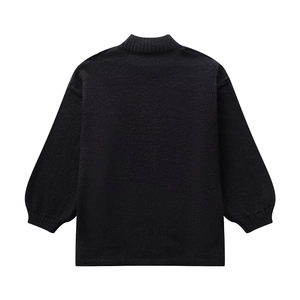 Detail of black knit sweater featuring mock neck, drop shoulders and ribbed cuffs