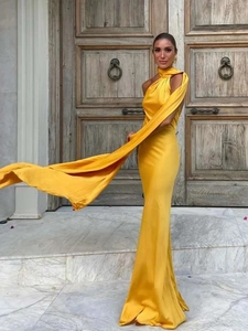 Detailed view of yellow satin halter neck dress featuring elegant side trailing ribbon