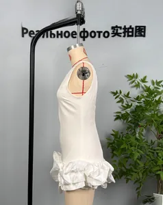 Detail of white sleeveless dress showing loose fit and pleated bubble hem on mannequin
