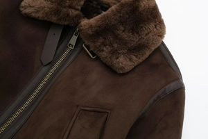 Detail of vintage dark brown suede aviator jacket with thick fur collar and metal zipper