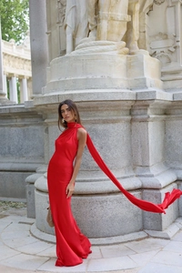Elegant red satin halter dress detail showing long flowing neck ties and backless design