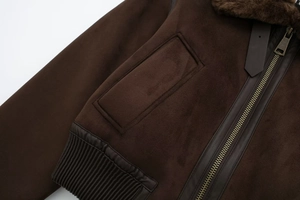 Detail of dark brown faux suede bomber jacket with faux fur collar and metal zipper