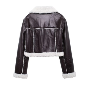 Macro detail of dark brown faux leather jacket with plush white shearling collar and cuffs