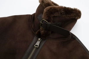 Detail of vintage brown suede flight jacket featuring faux shearling collar and buckles