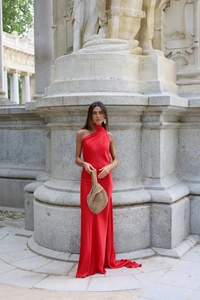 Detail of red satin backless maxi dress featuring a high-neck ribbon and silky texture