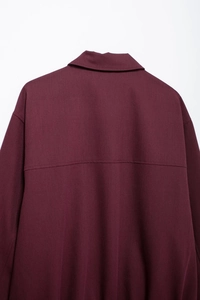 Detail view of the back collar and stitching on this burgundy zip jacket for women