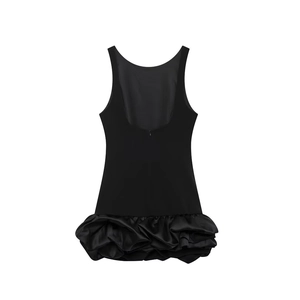 Detail of black backless mini dress with oversized ruffled hem and invisible zipper