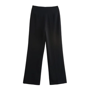 Detail view of high-waisted black wide-leg trousers with elegant flowing drape