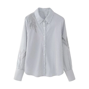 Detail of silver leaf beaded embroidery on long sleeve striped button-down shirt