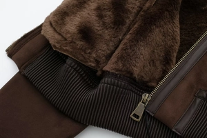 Detailed macro view of vintage brown suede jacket with faux fur lining and bronze zipper