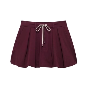 Detail of burgundy bubble skirt with pleated hem and adjustable cream drawstring cord