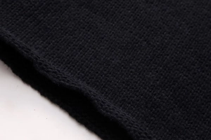 Close-up detail of the premium black knit fabric showing soft fine-needle weaving texture