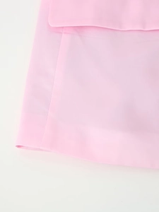Detailed view of light pink satin skirt featuring clean stitching and pocket flap design