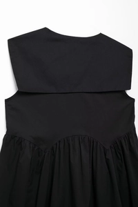 Detail of the square neckline and fine gathered pleats on this black fashion dress