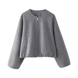 Close-up of soft grey wool texture and metal zipper detail on women's cropped jacket