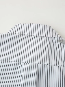 Detail of beaded embroidery on striped shirt collar with high quality stitching
