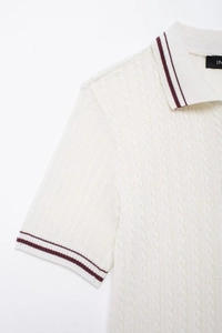 Close-up of cable-knit texture and burgundy stripes on cream short sleeve polo shirt