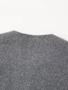 Close-up detail of dark grey soft fleece fabric texture on a fashion jacket neckline