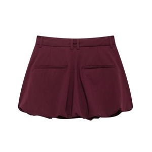 Detail view of wine red high-waist bubble hem skort with belt loops and back pockets