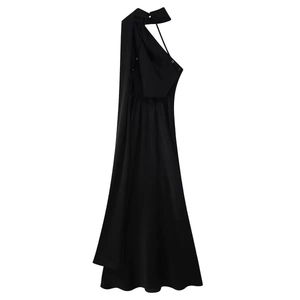 Detail of elegant black satin halter dress featuring metal button and long flowing ribbon