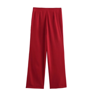 Detailed flat lay of red wide-leg trousers with elegant front pleats and smooth waistband
