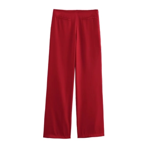 Red wide-leg high-waisted trousers with decorative front pockets and sleek fluid fabric