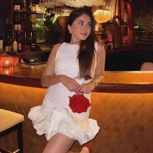 Elegant white sleeveless mini dress with voluminous ruffled hem for a chic evening look