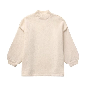 Women's cream oversized knit sweater with high mock neck and ribbed cuff details
