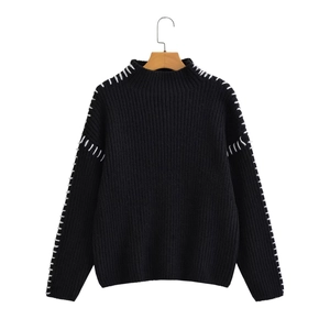 Black knit sweater with contrast white stitching and ribbed texture in a casual fit