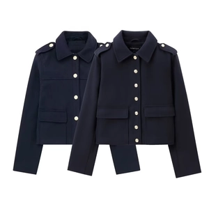 Detail of navy blue cropped jackets with gold buttons, epaulettes and cargo pockets