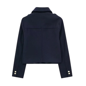 Detailed back view of a navy wool jacket featuring structured seams and gold buttons