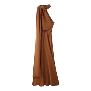 Detail of the backless neck tie and silky caramel satin fabric on a long maxi dress
