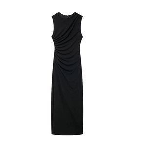 Close-up of elegant side ruching and asymmetrical pleated details on a black midi dress