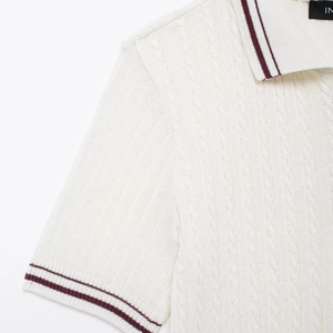 Women's cable knit short sleeve polo top with ribbed texture and striped collar detail