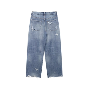 Detail of vintage high-waisted baggy jeans with distressed rips and raw hem on the back