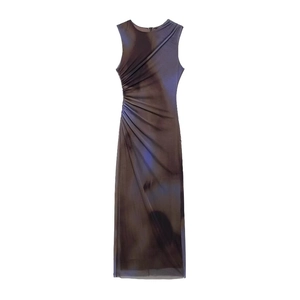 Detail of the elegant ruched side design and purple gradient pattern on the midi dress
