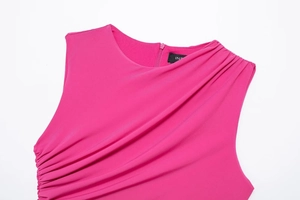 Detail view of fuchsia midi dress showing ruched pleated fabric and invisible zipper