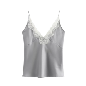 Detailed close-up of silver satin camisole featuring delicate white lace trim on the V-neckline