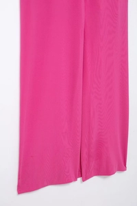 Detailed close-up of rose red midi dress featuring side slit and ribbed texture fabric