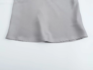 Detail of the gray satin fabric hem with high-quality stitching and a smooth silky finish