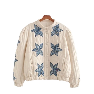 Quilted off-white jacket with blue floral star embroidery and elasticated hem details